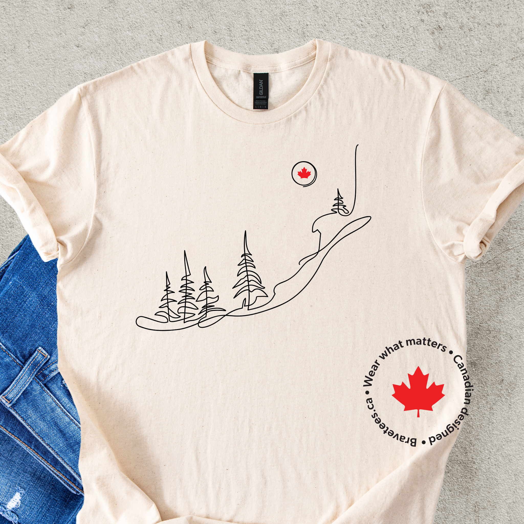 Cream t-shirt with nature-themed design and Canadian maple leaf